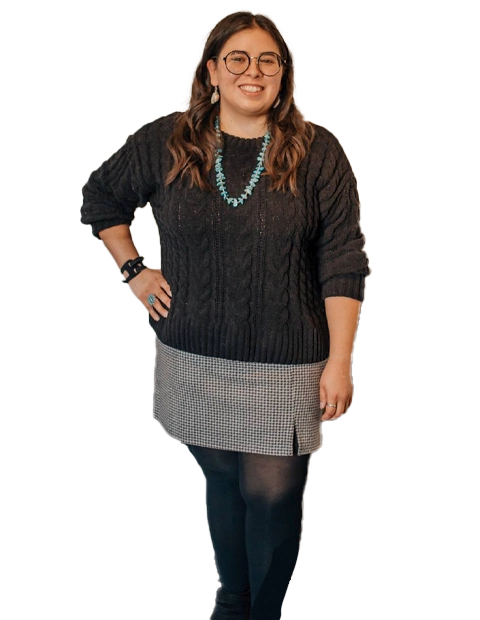 Dr. Lindsay Hall stand up with a black sweeter.